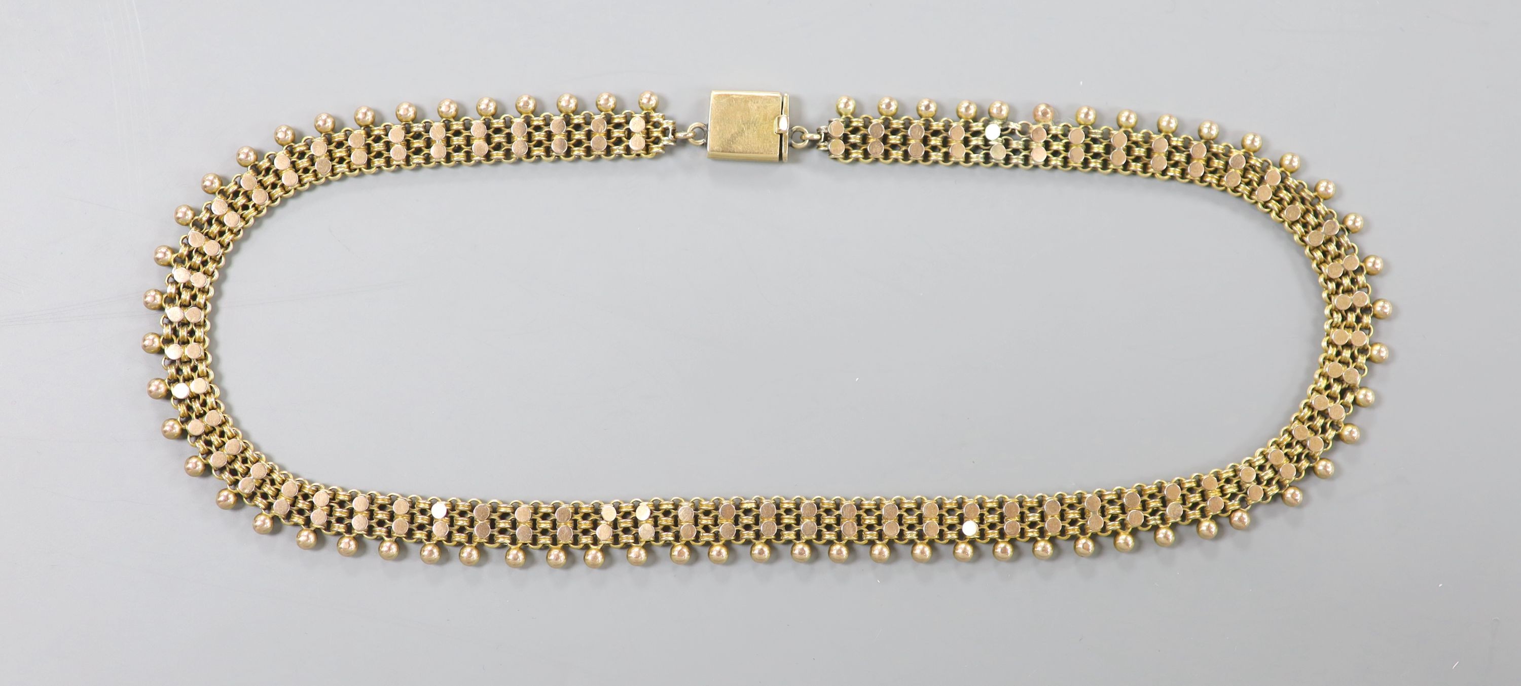 An early 20th century yellow metal fancy link and bead choker necklace, 42cm